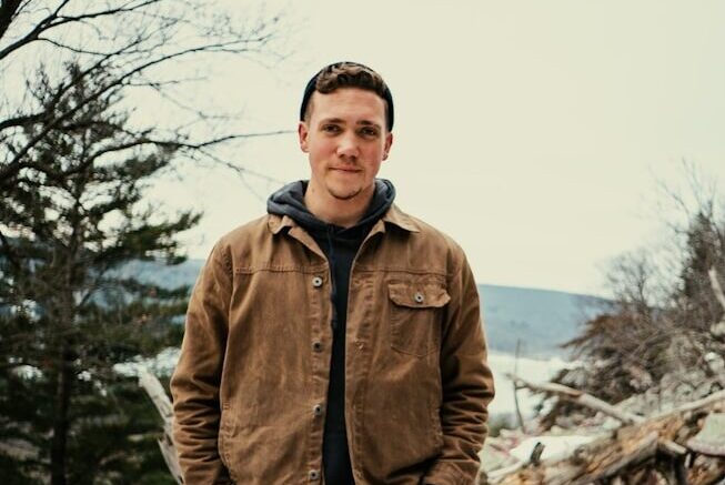 a man standing on top of a pile of snow